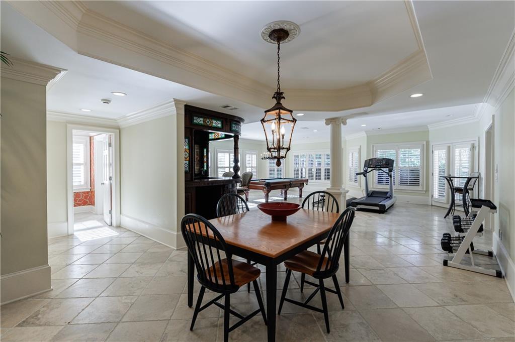9390 Colonnade Trail Alpharetta, GA 30022 - Photo 84 of 122 a view of a dining room and livingroom with furniture wooden floor a chandelier