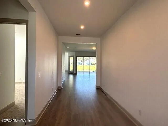 a view of hallway with wooden floor