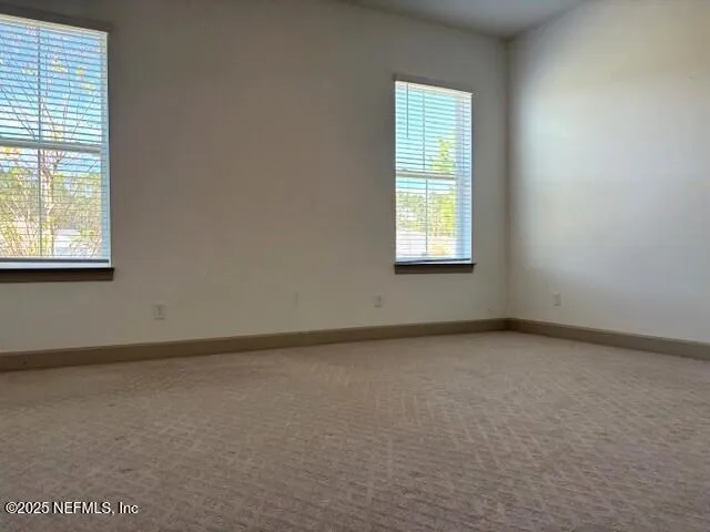 a large kitchen with stainless steel appliances kitchen island a large counter top and wooden floors