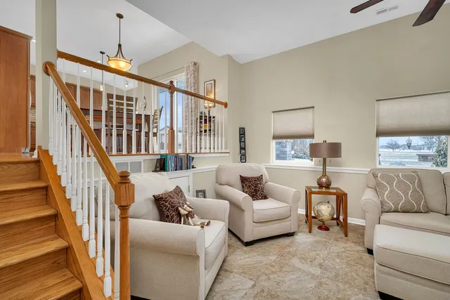 a living room with furniture and a chandelier