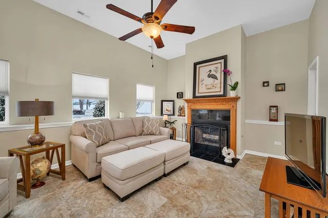 a living room with furniture a fireplace and a flat screen tv