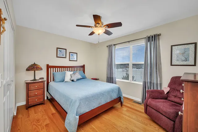 a bedroom with a bed couch and a window