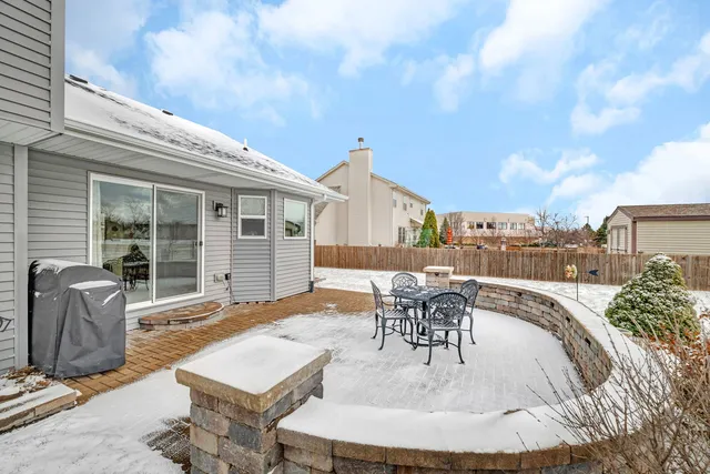 a view of a patio with table and chairs and potted plants