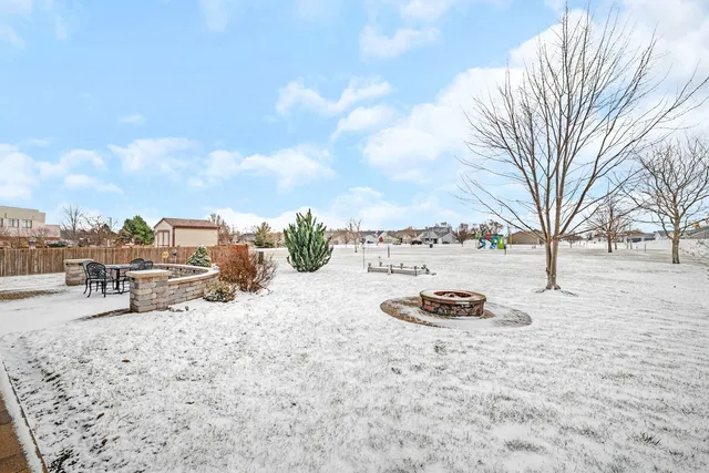 a view of a dry yard with snow on the road