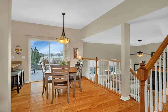 a dining room with furniture a chandelier and wooden floor