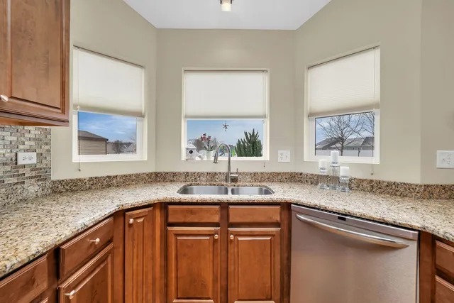 a kitchen with granite countertop a sink and a window