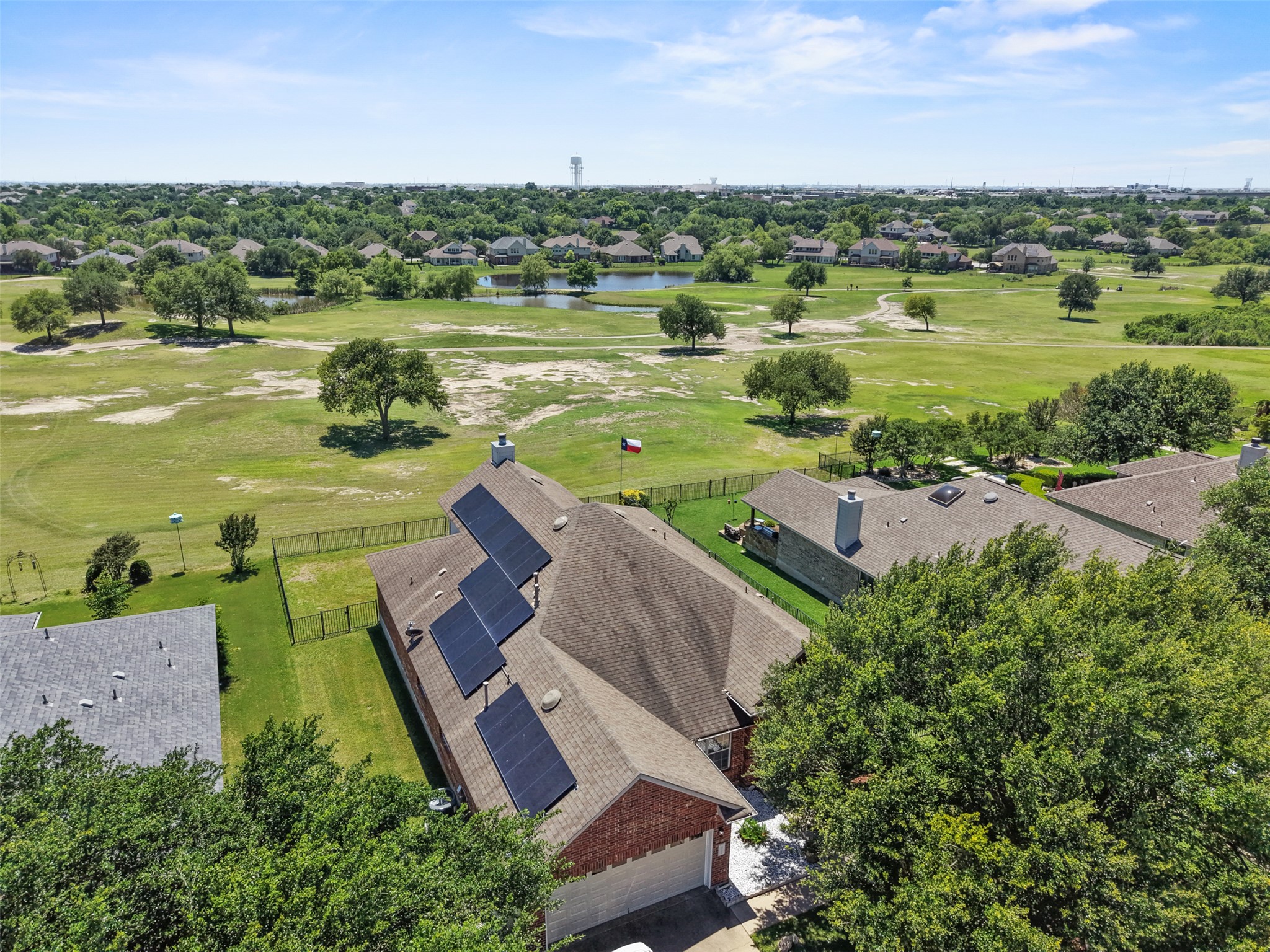 2521 Amen Corner Road Pflugerville, TX 78660 - Photo 37 of 40 Brick exterior with a shingle roof and integrated solar panels