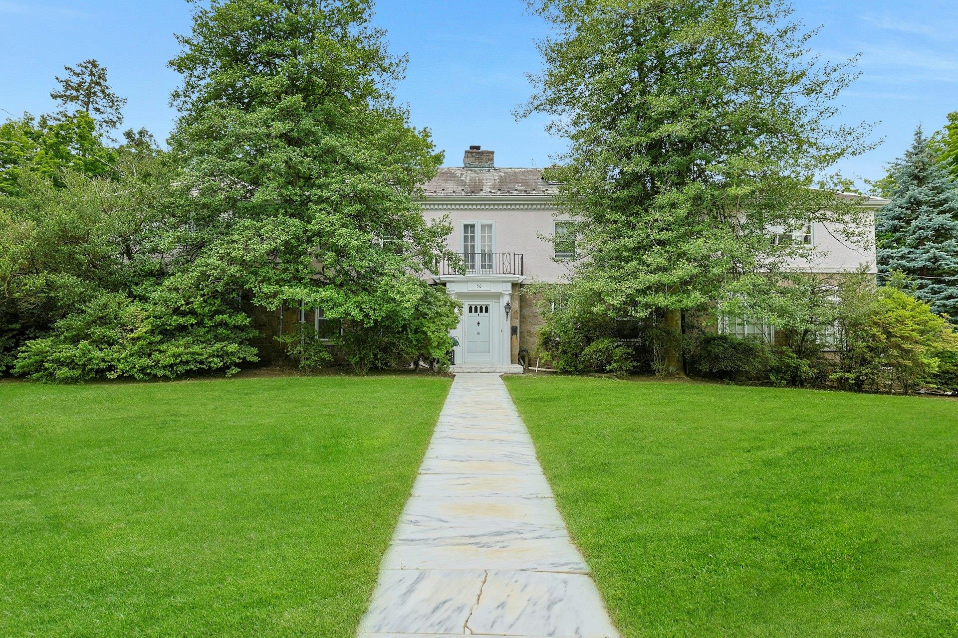 50 Forest Circle New Rochelle, NY 10804 - Photo 1 of 1 a view of a brick house with a big yard and large trees