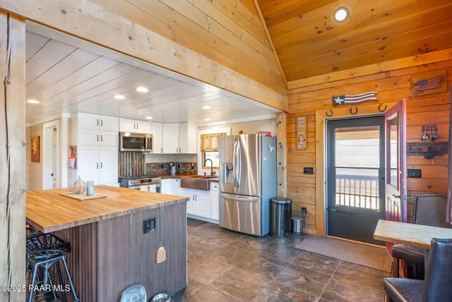 a view of a patio with couches chairs and potted plants