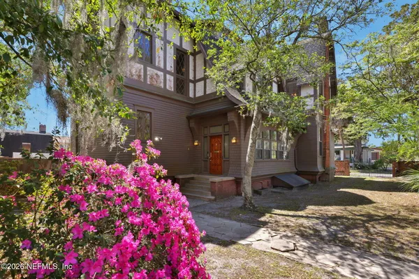 a view of a house with a tree