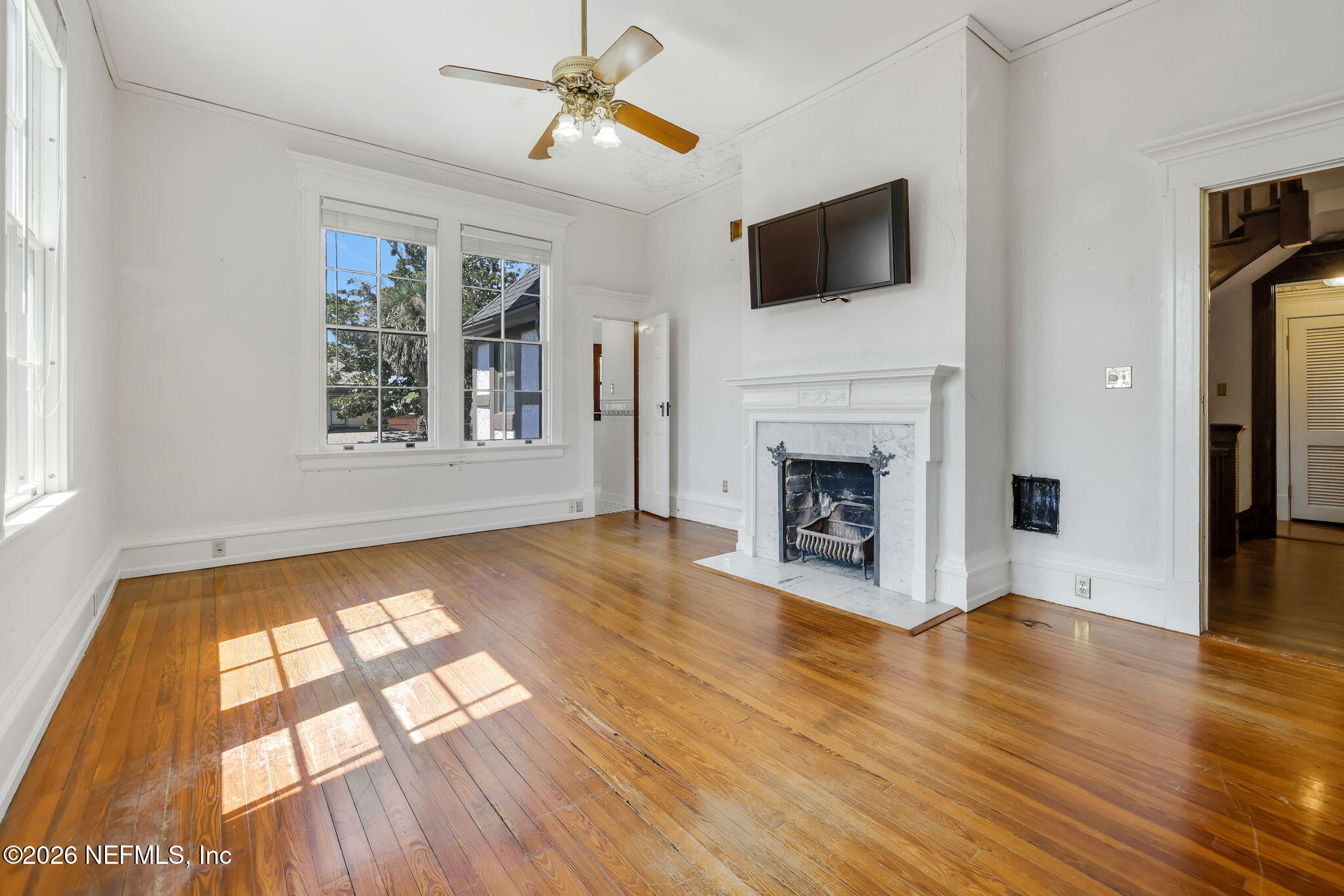 2160 Oak Street Jacksonville, FL 32204 - Photo 66 of 143 a view of an empty room with wooden floor fireplace and a window