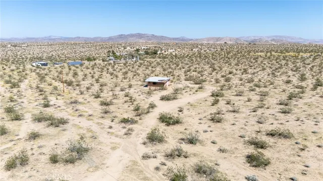 a street sign on a sidewalk next to a road