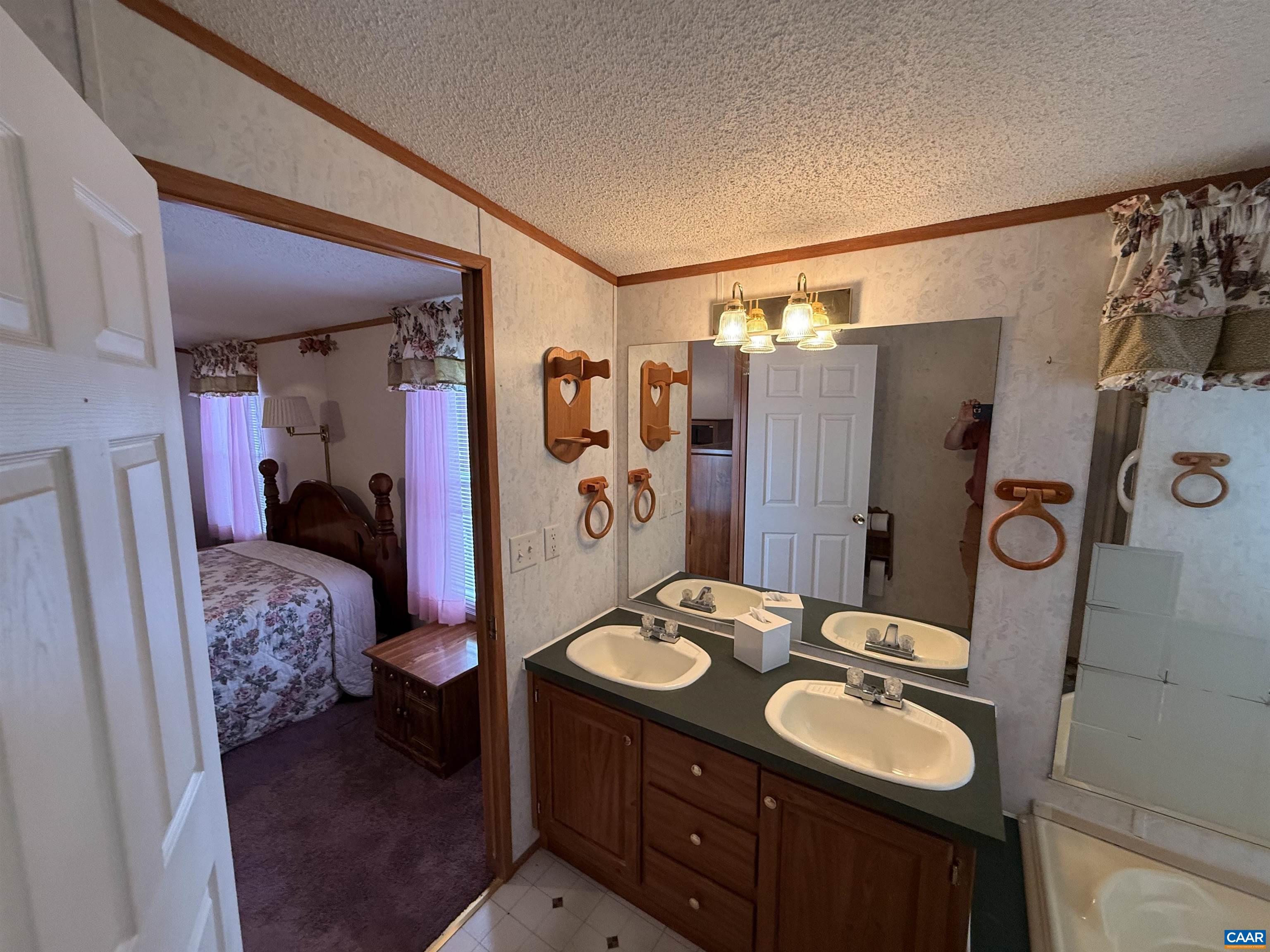 220 Chalklevel Road Louisa, VA 23093 - Photo 20 of 43 a bathroom with a sink vanity granite tub shower and mirror