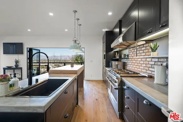 a kitchen with stainless steel appliances granite countertop a stove and a sink