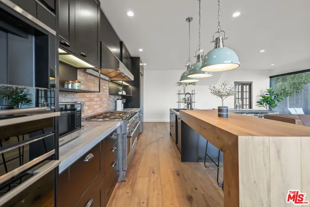 a living room with kitchen island furniture and a flat screen tv