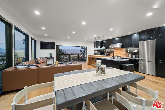 a bedroom with two beds and a flat screen tv