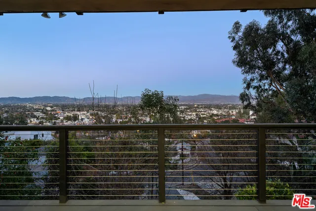 a view of city and trees from a balcony