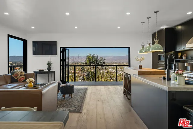 a living room with a flat screen tv and a large window
