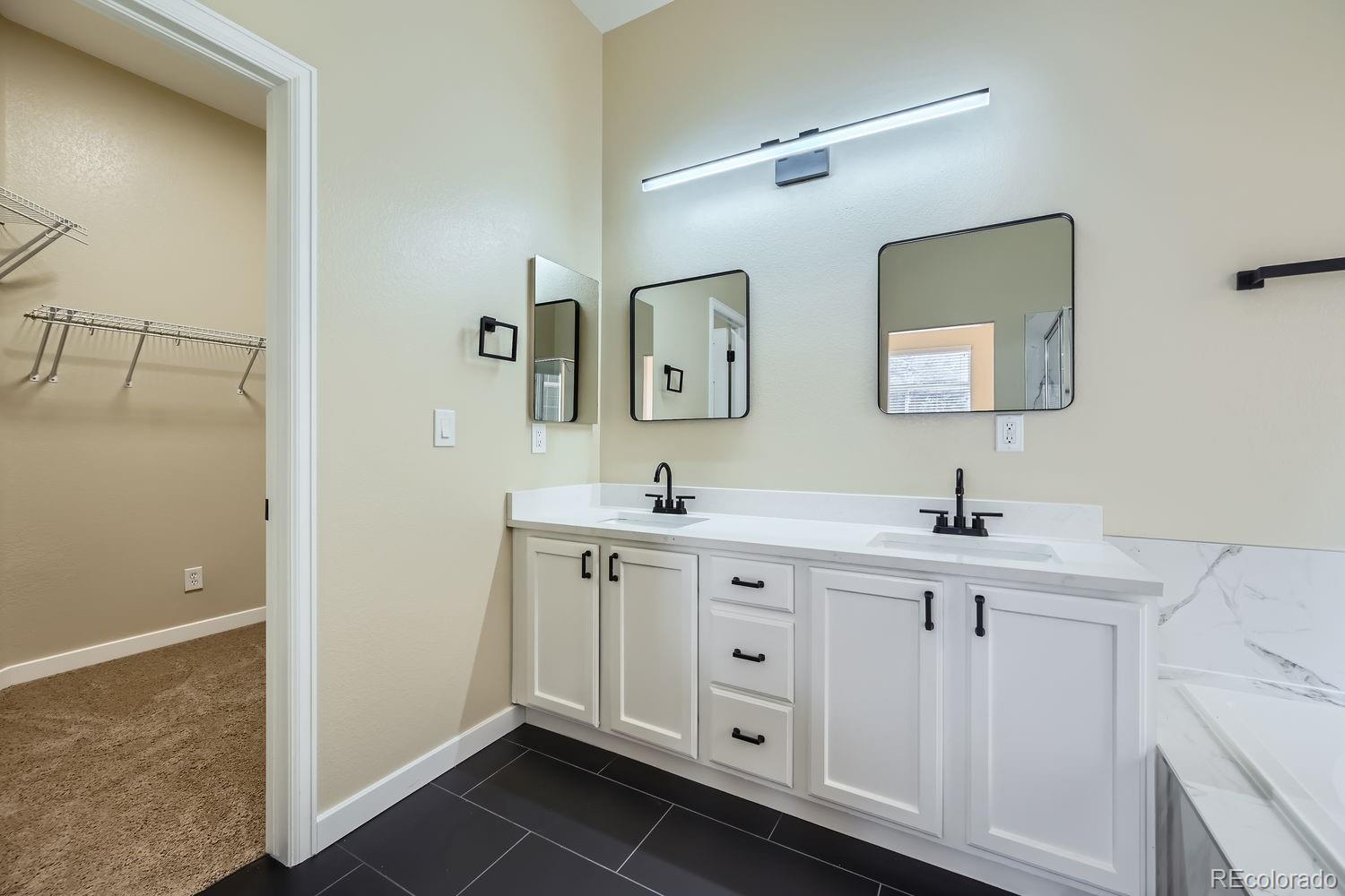 6596 Silverleaf Avenue Firestone, CO 80504 - Photo 12 of 26 a spacious bathroom with a double vanity sink mirror and