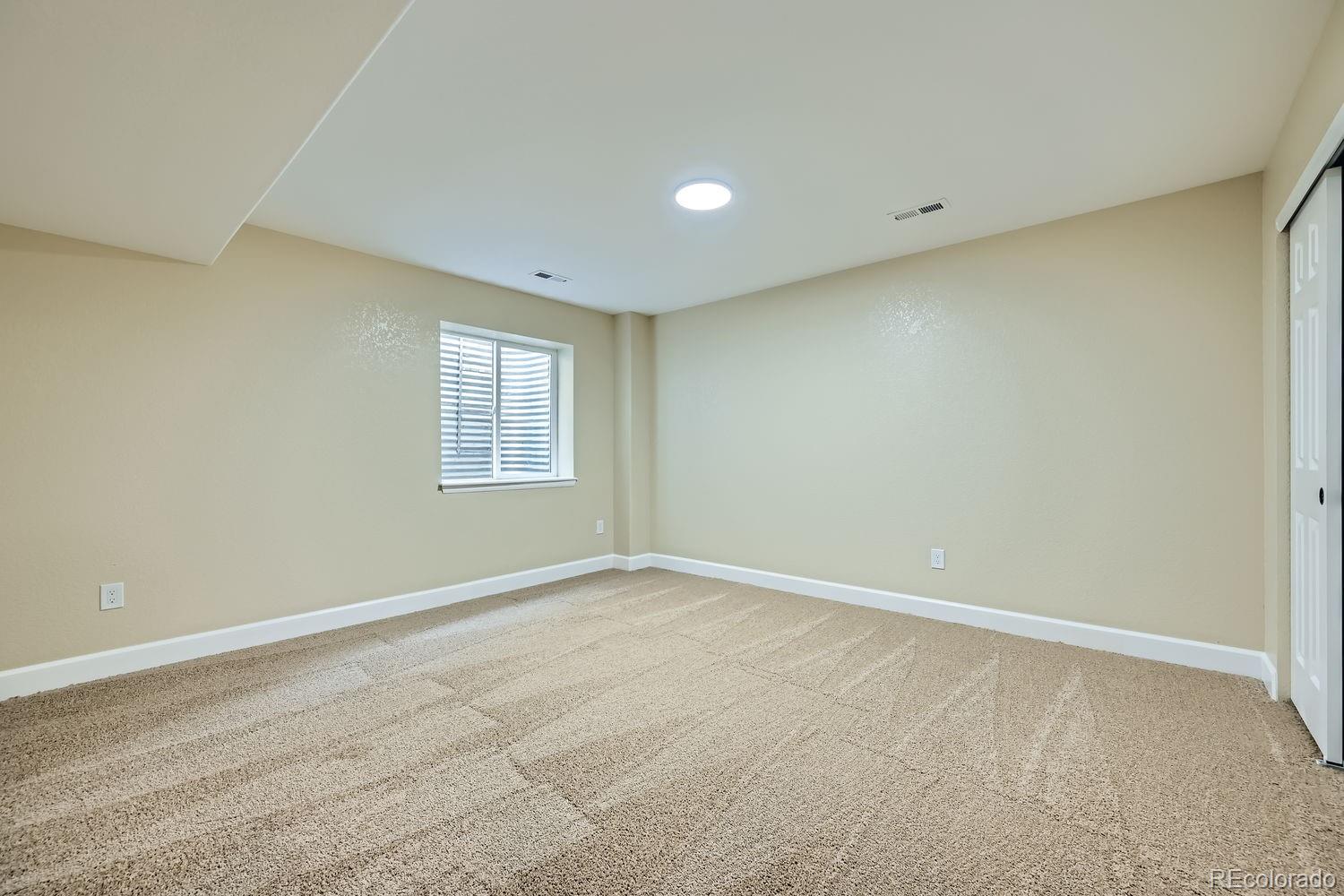 6596 Silverleaf Avenue Firestone, CO 80504 - Photo 19 of 26 a view of an empty room with windows