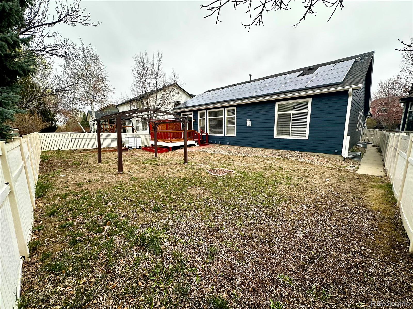 6596 Silverleaf Avenue Firestone, CO 80504 - Photo 25 of 26 a backyard of a house with table and chairs