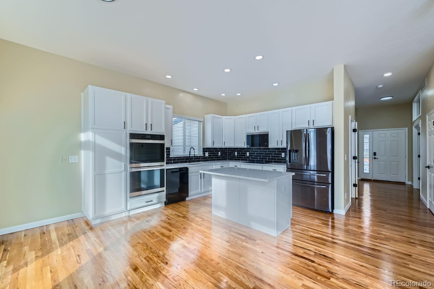 6596 Silverleaf Avenue Firestone, CO 80504 - Photo 8 of 26 a kitchen with refrigerator and microwave