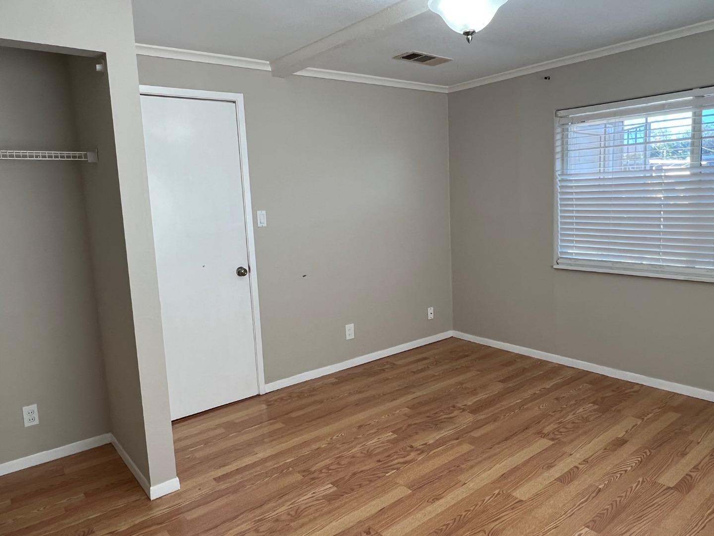 2829 Hilltop Road Concord, CA 94520 - Photo 11 of 20 an empty room with wooden floor and windows