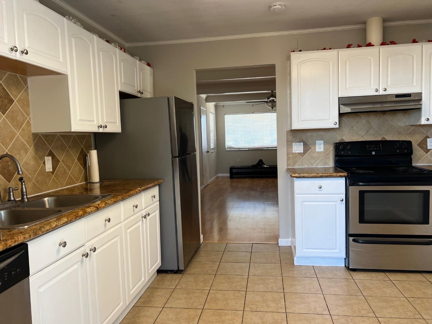 2829 Hilltop Road Concord, CA 94520 - Photo 8 of 20 a kitchen with granite countertop white cabinets and stainless steel appliances