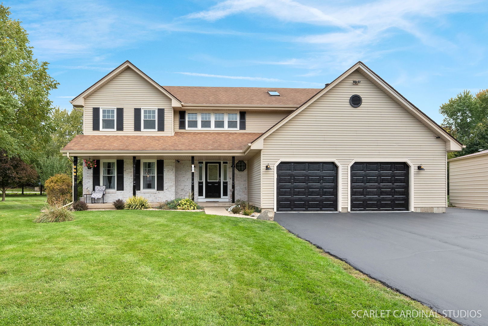 a front view of a house with a yard and garage