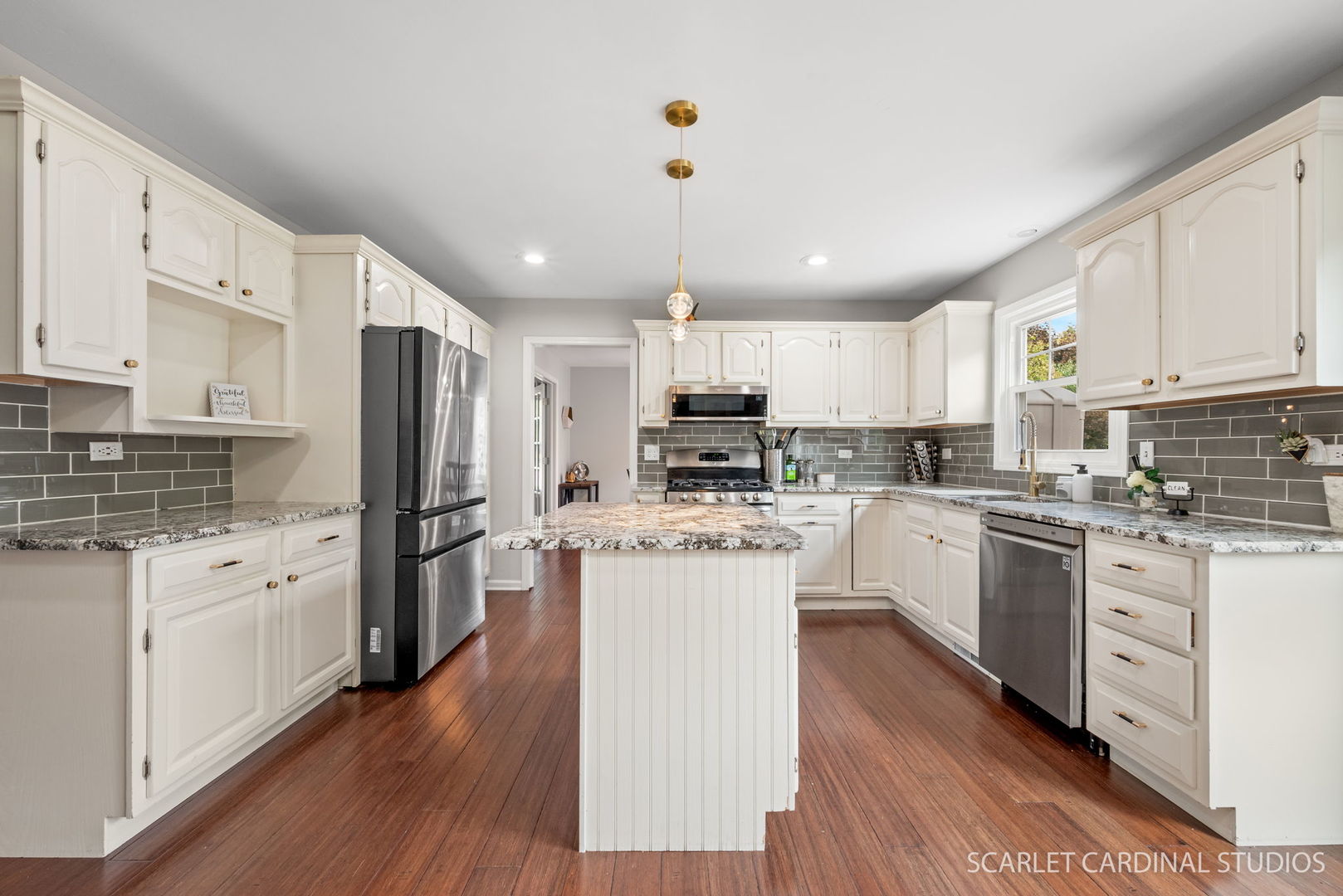12N619 Jackson Drive Elgin, IL 60124 - Photo 11 of 50 a kitchen with white cabinets and stainless steel appliances