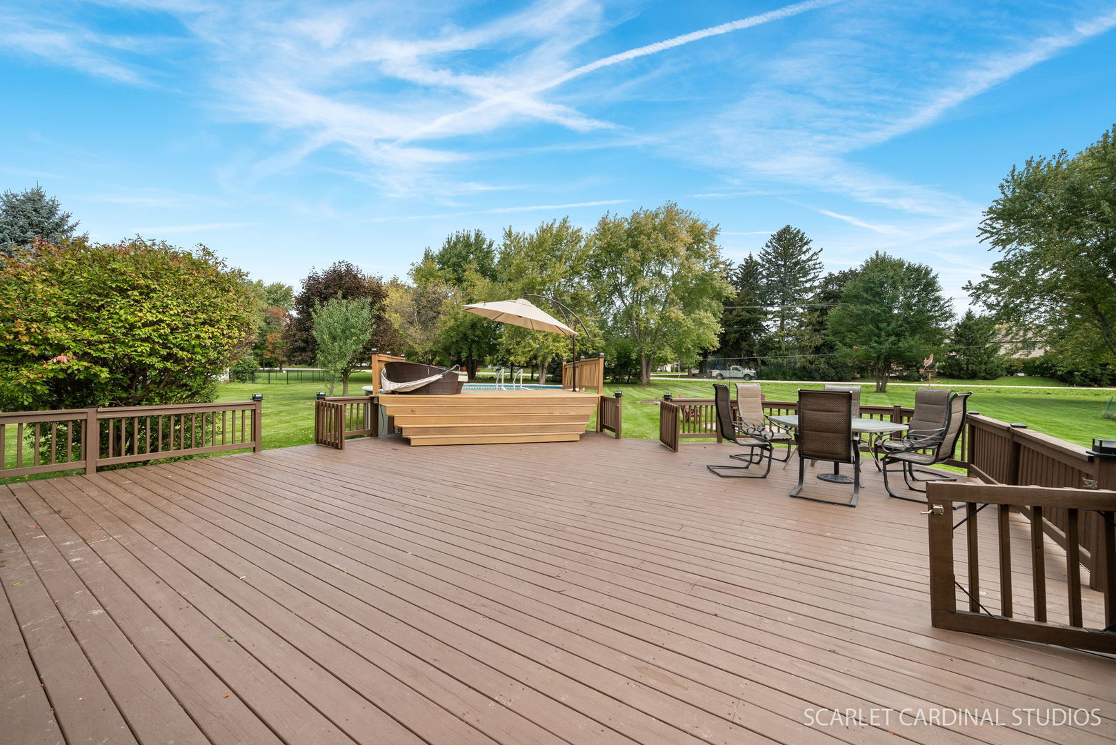 12N619 Jackson Drive Elgin, IL 60124 - Photo 39 of 50 a view of a roof deck with table and chairs a barbeque with wooden floor and fence