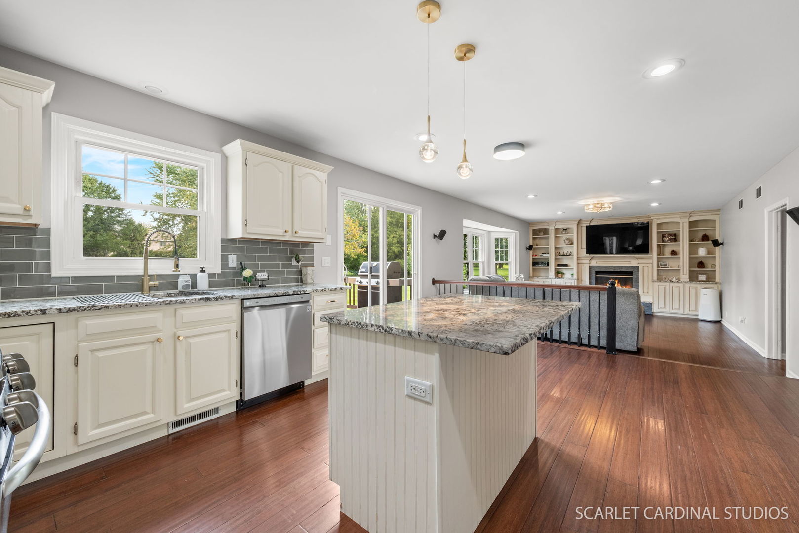 12N619 Jackson Drive Elgin, IL 60124 - Photo 10 of 50 a kitchen with stainless steel appliances granite countertop wooden floors and white cabinets