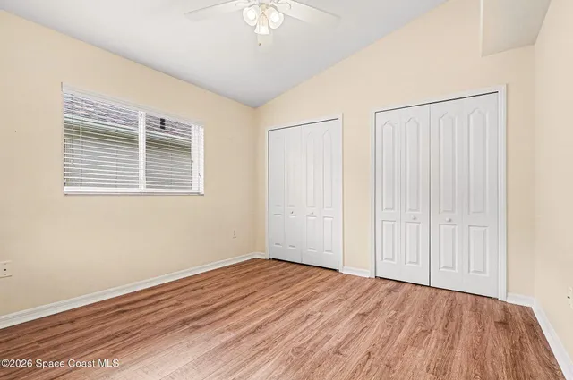 a bedroom with a bed and a flat screen television