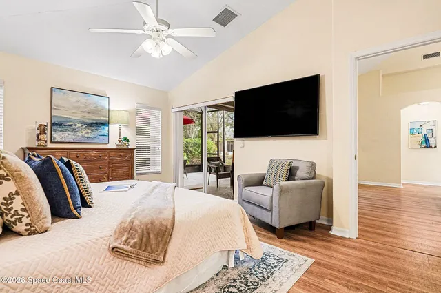 a view of a patio with a table and chairs under an umbrella