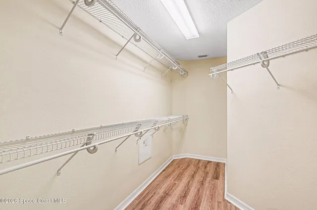 a view of a house with a yard and potted plants