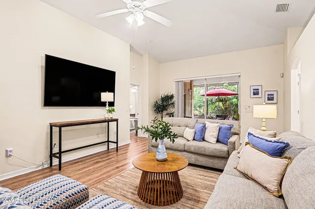 a living room with furniture and wooden floor