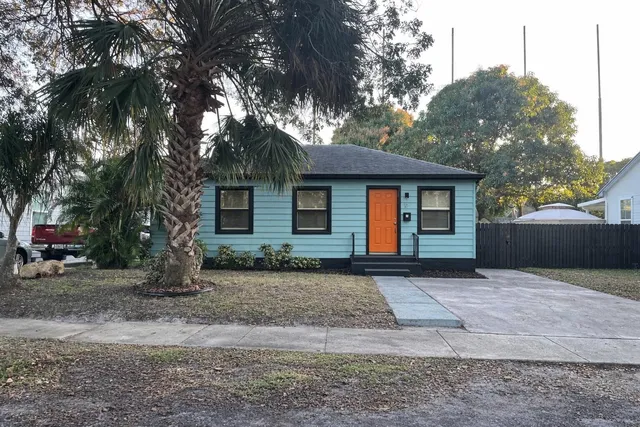 a front view of a house with a yard and a garage