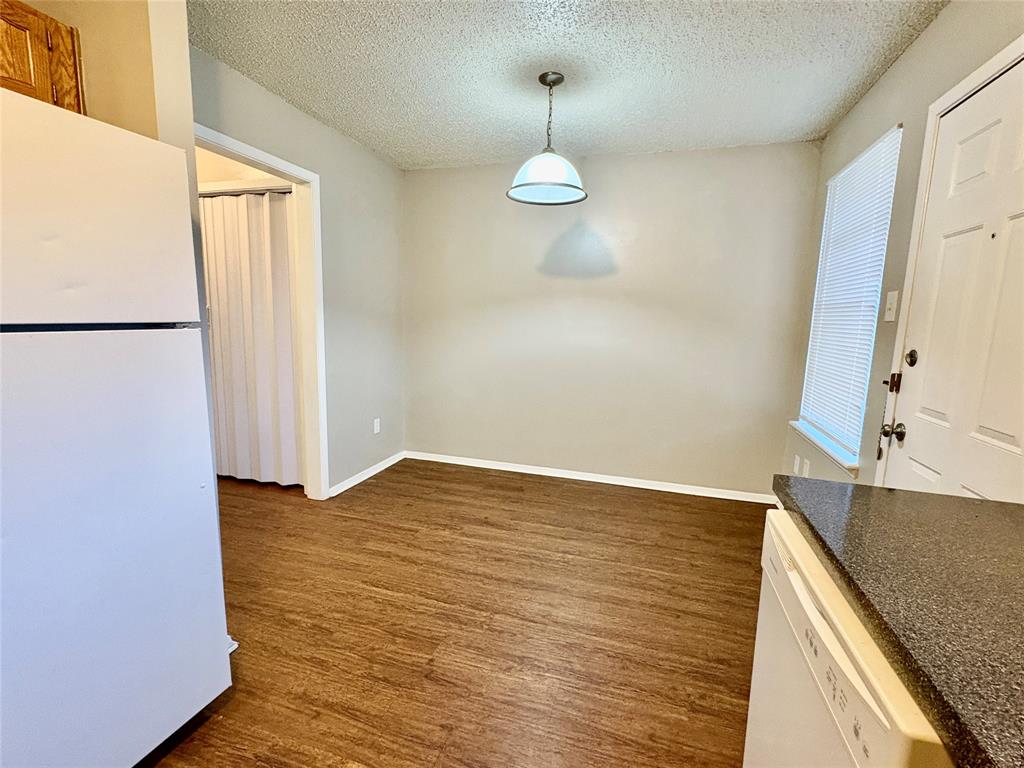 1407 Courtney Place, Unit B Cleburne, TX 76033 - Photo 3 of 16 a view of an empty room with wooden floor and a window