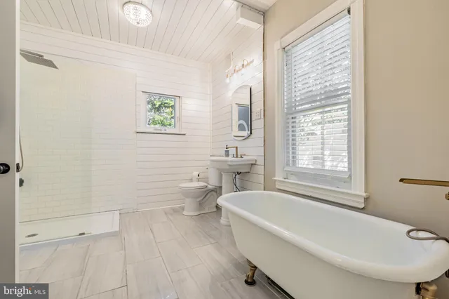 a white bath tub sitting next to a white toilet