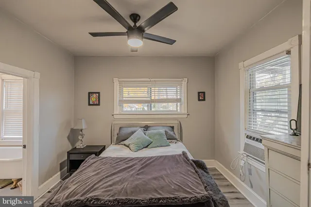 a bedroom with a large bed and a window