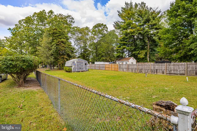 a view of a swimming pool with a patio and garden