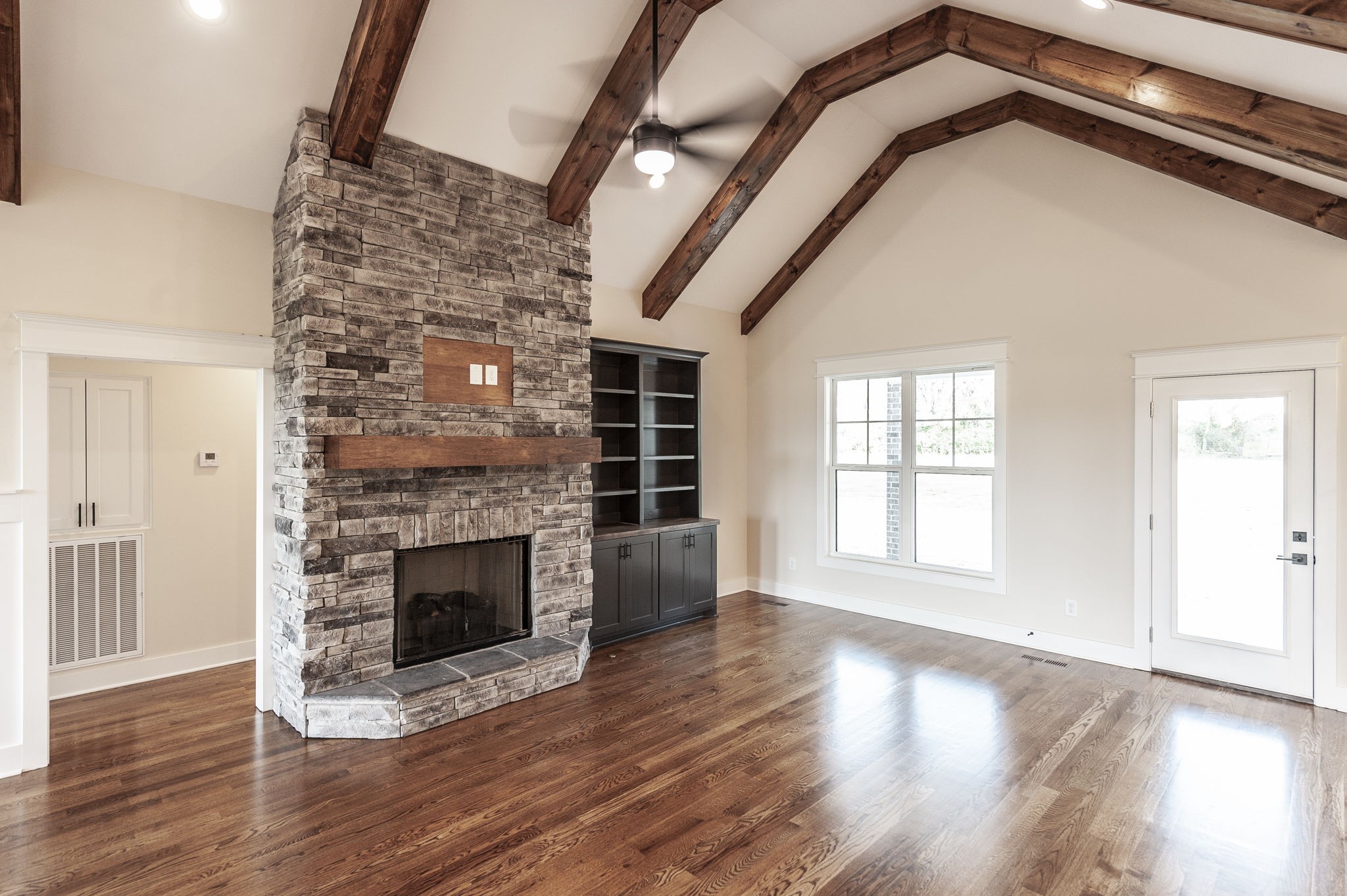 1060 Millbrook Way Gallatin, TN 37066 - Photo 15 of 79 an empty room with wooden floor fireplace and windows