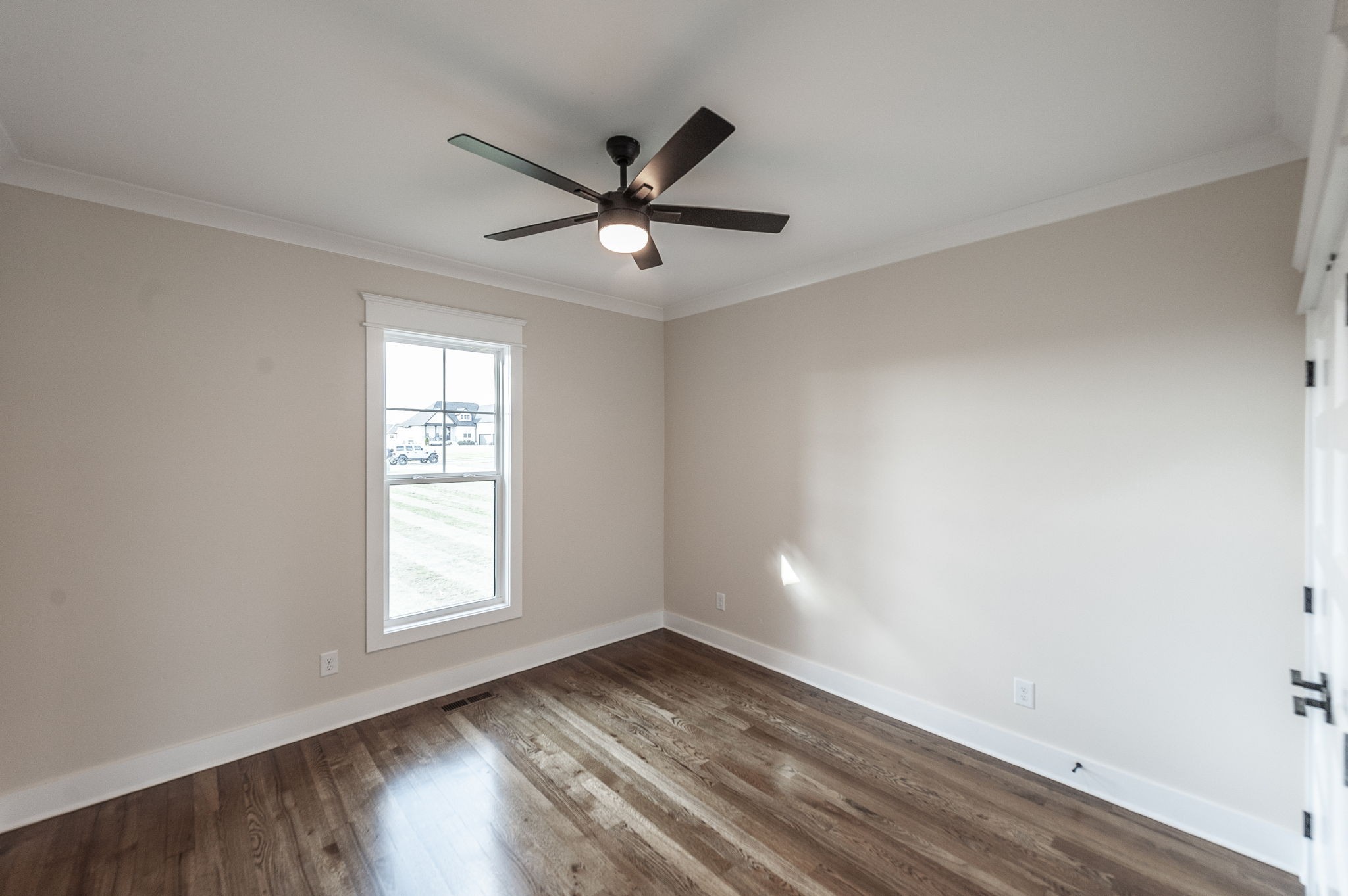 1060 Millbrook Way Gallatin, TN 37066 - Photo 48 of 79 an empty room with wooden floor fan and windows