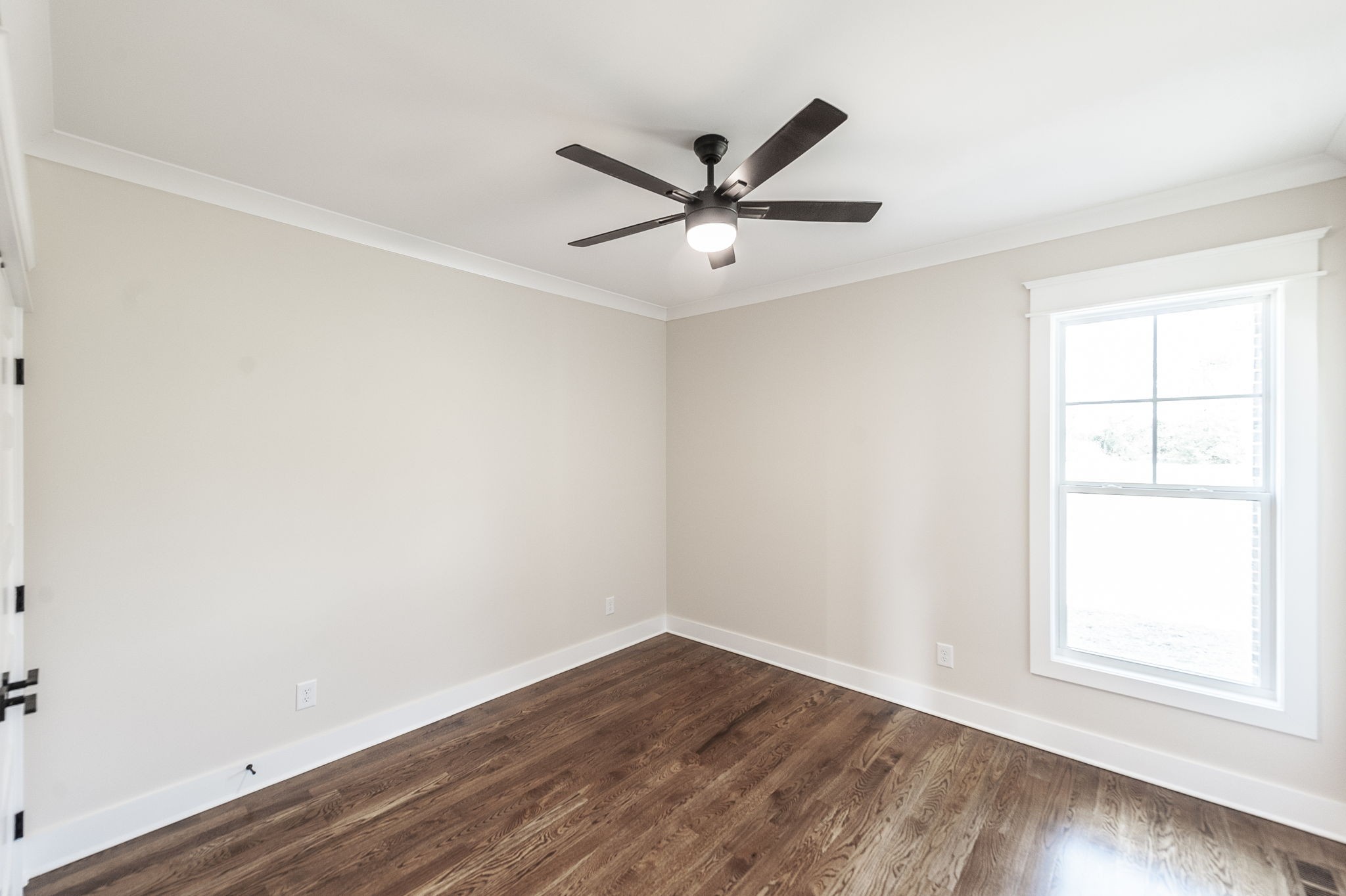 1060 Millbrook Way Gallatin, TN 37066 - Photo 54 of 79 an empty room with wooden floor a ceiling fan and windows
