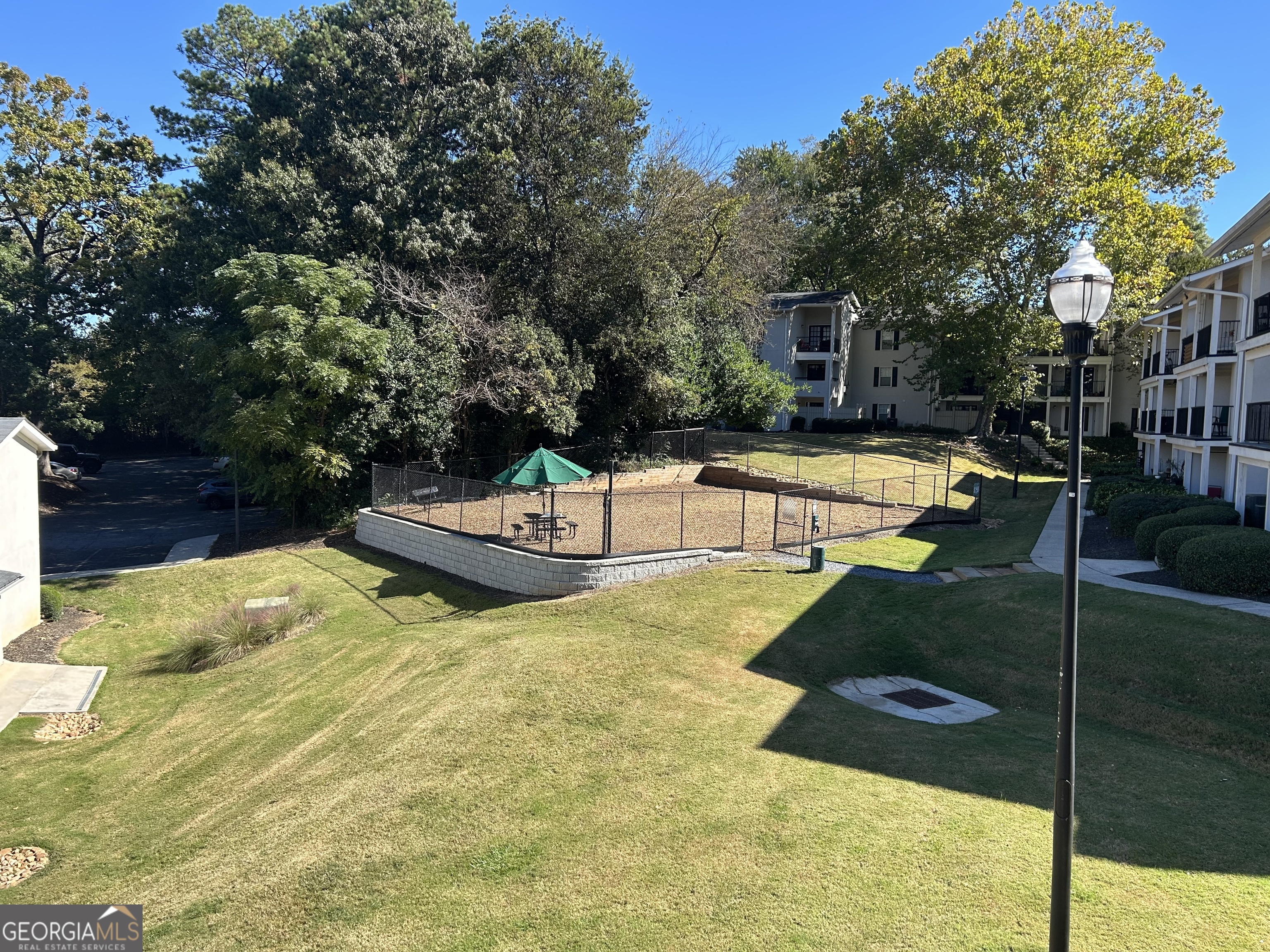 1150 Collier Road Northwest, Unit H9 Atlanta, GA 30318 - Photo 11 of 13 a swimming pool with some trees