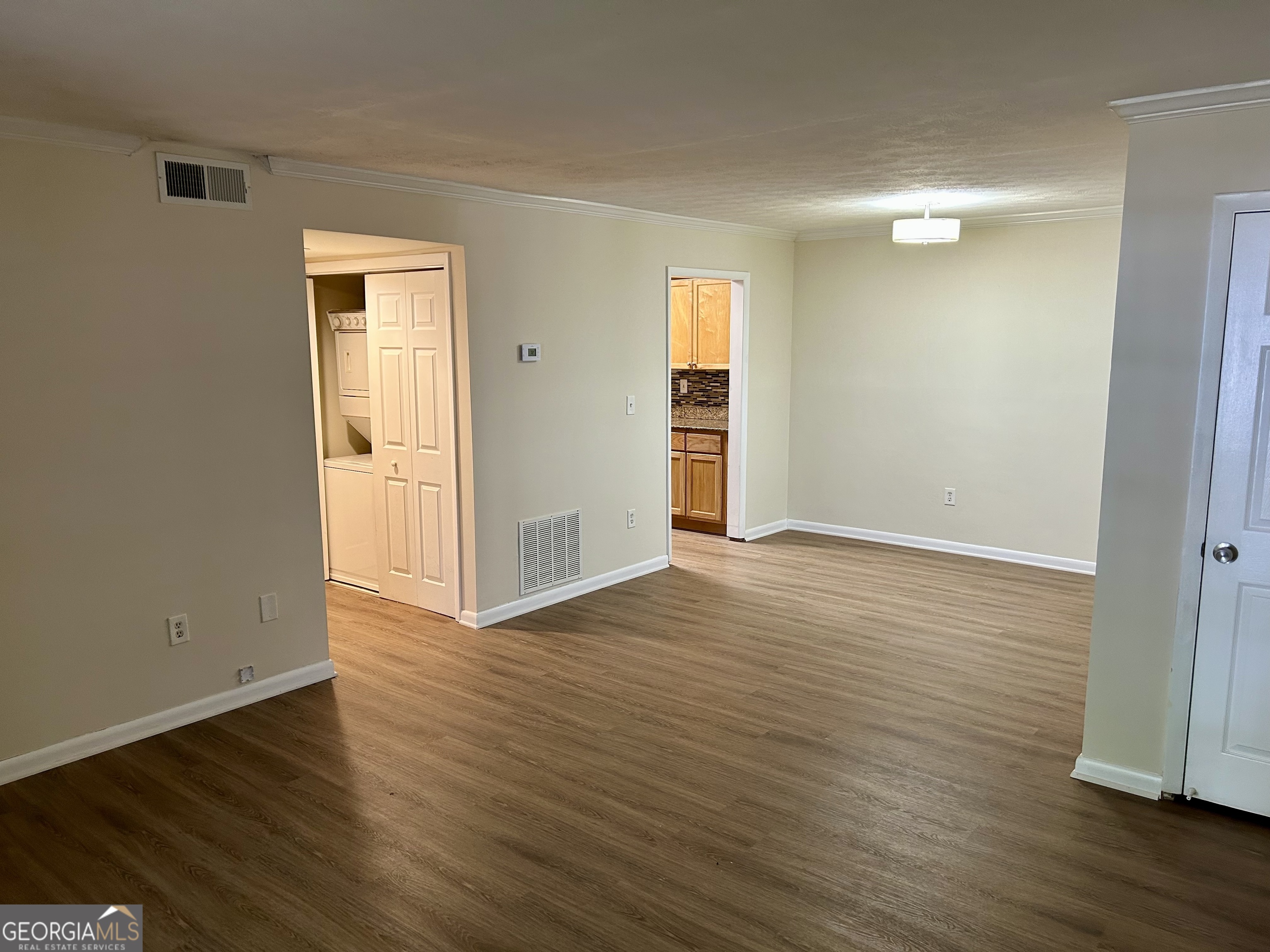 1150 Collier Road Northwest, Unit H9 Atlanta, GA 30318 - Photo 5 of 13 an empty room with wooden floor and windows
