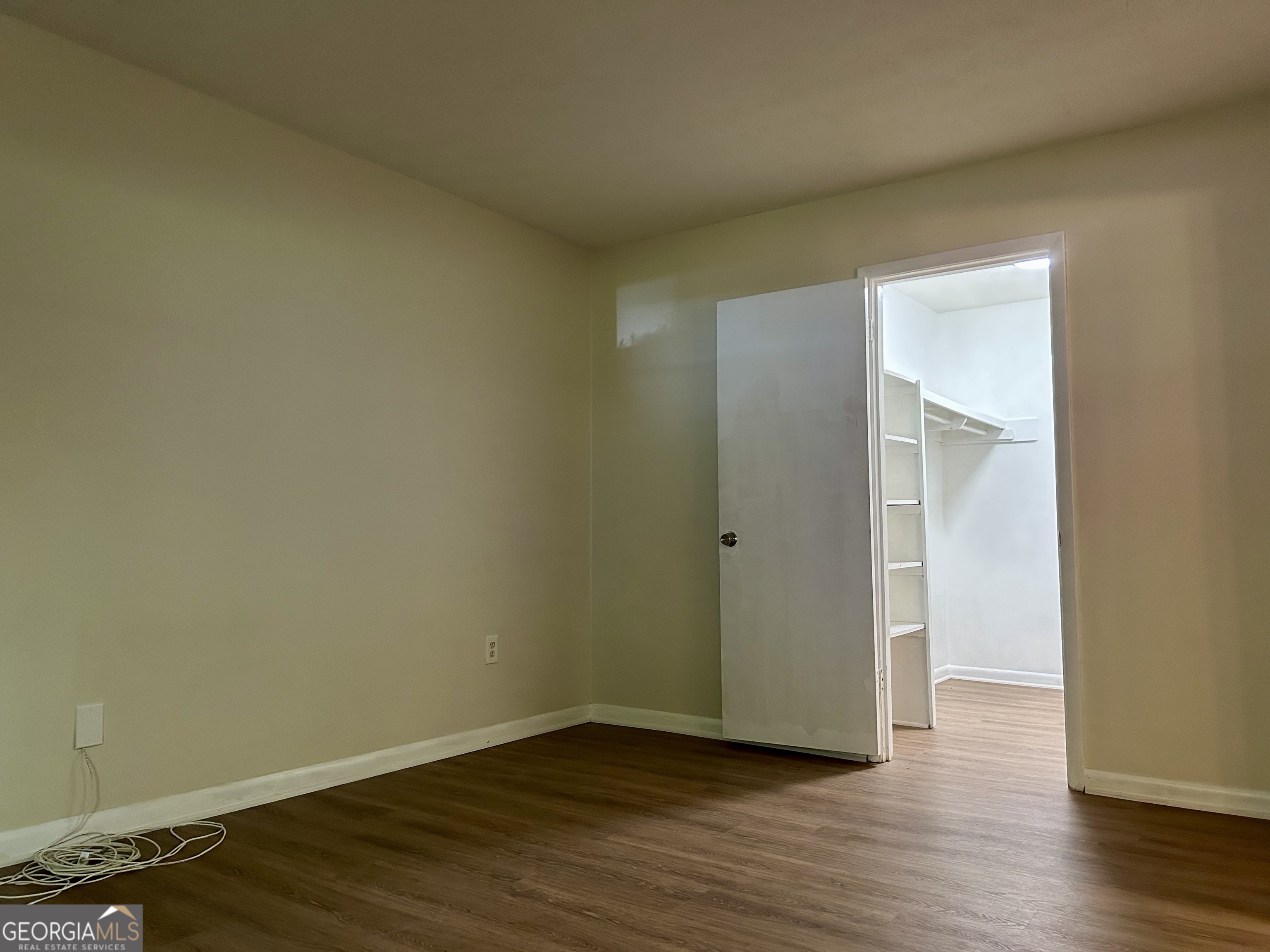 1150 Collier Road Northwest, Unit H9 Atlanta, GA 30318 - Photo 10 of 13 a view of an empty room with wooden floor and closet