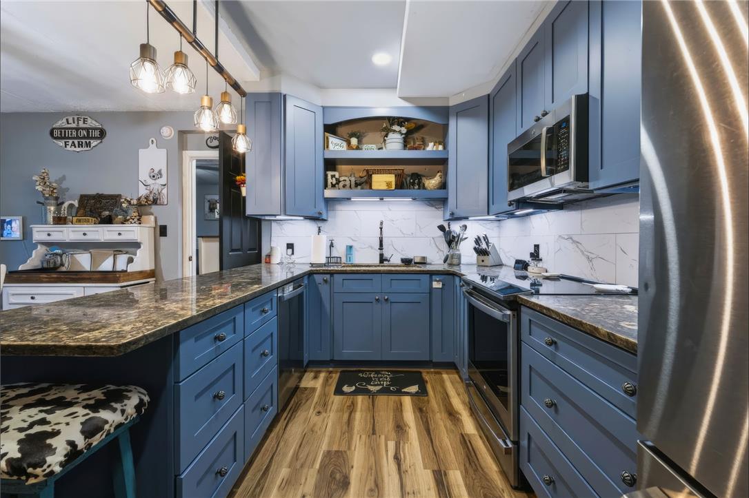 74 Turkey Road Kempton, PA 19529 - Photo 12 of 65 A well-appointed kitchen features rich granite countertops and stylish blue cabinetry.