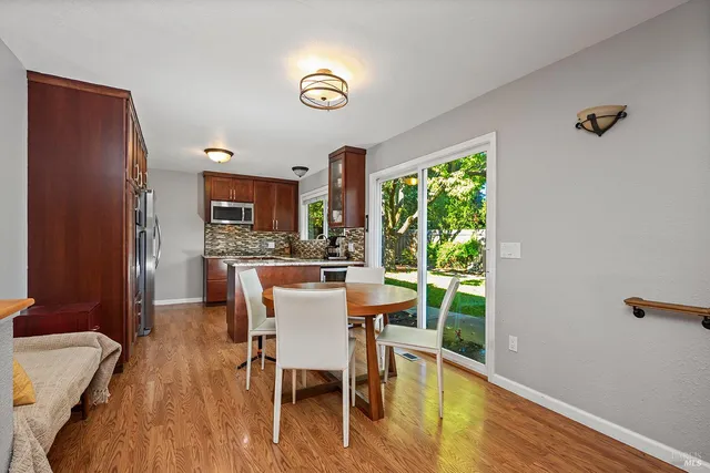 a dining room with furniture a window and wooden floor