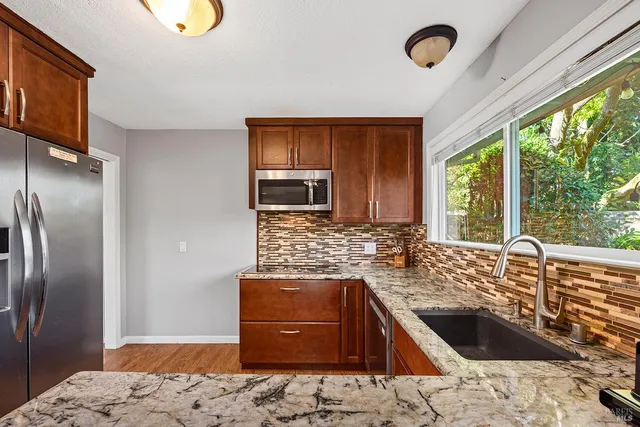 a kitchen with a sink stove and refrigerator